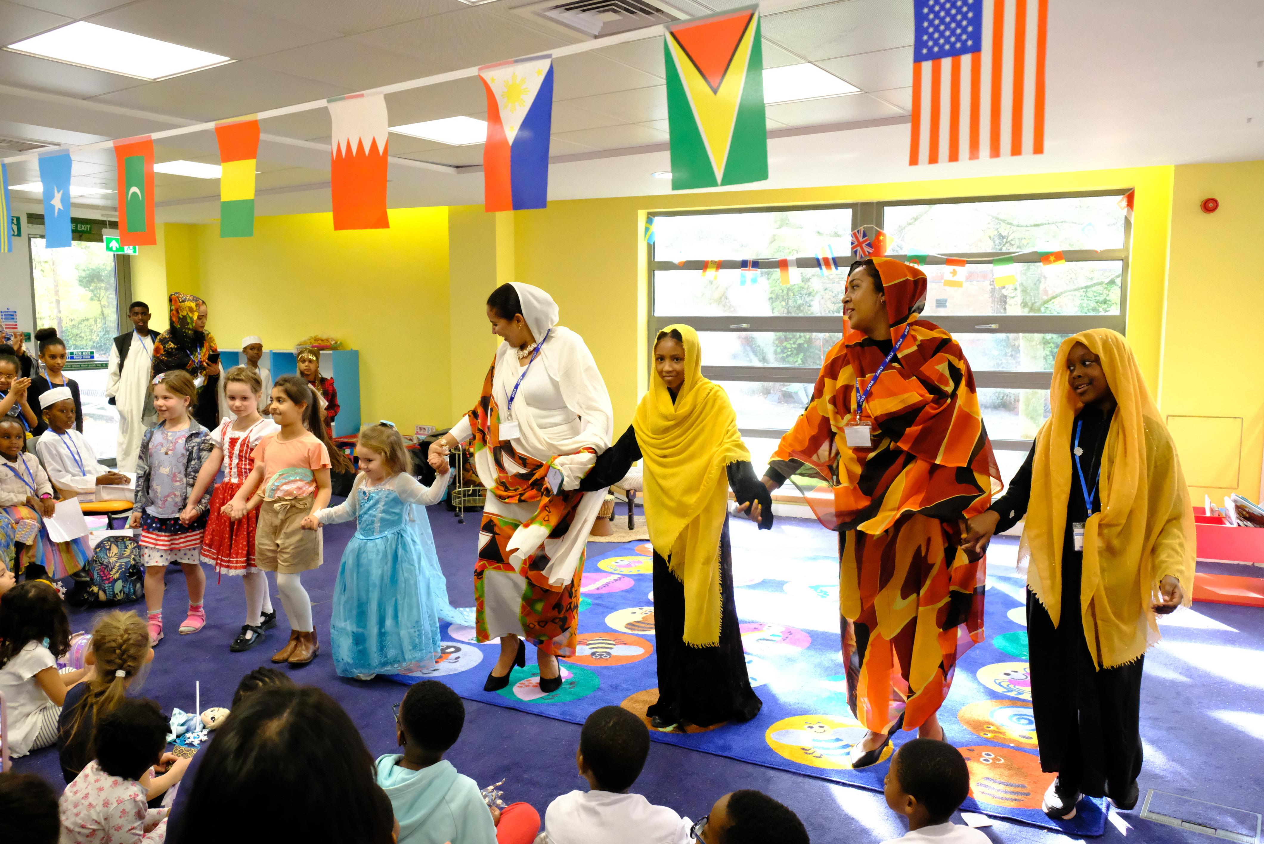 Families, including adults and children lined up for dancing. 