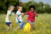 EAL Image of children playing with a ball in a field